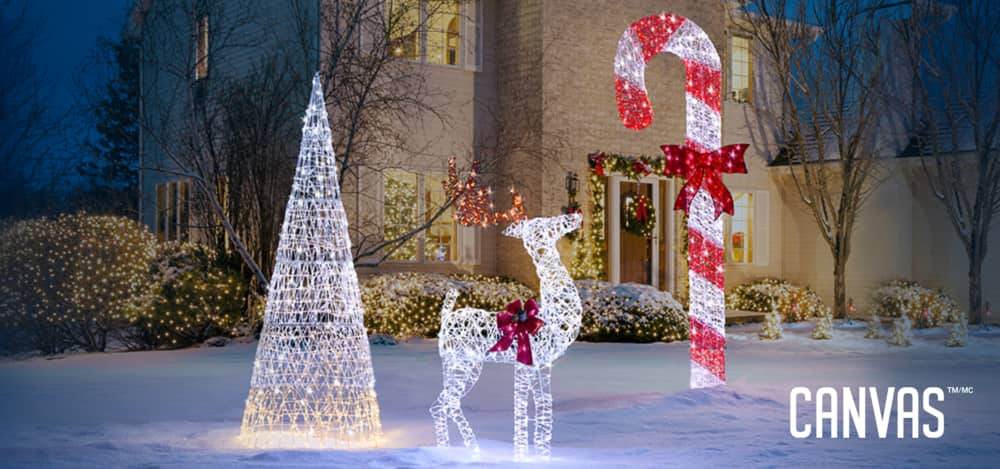 Micro-Brite Deer, Twinkling Cone Tree, and Candy Cane lit up on a snowy yard.