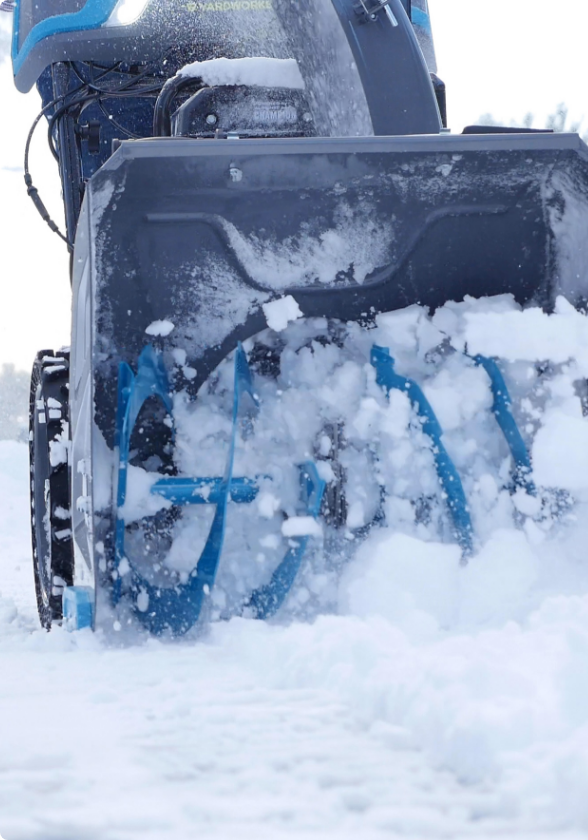 Close-up photo of a Yardworks 2-Stage Gas Snowblower’s augers breaking up snow.