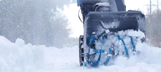 Close-up photo of a Yardworks 2-Stage Gas Snowblower’s augers breaking up snow.