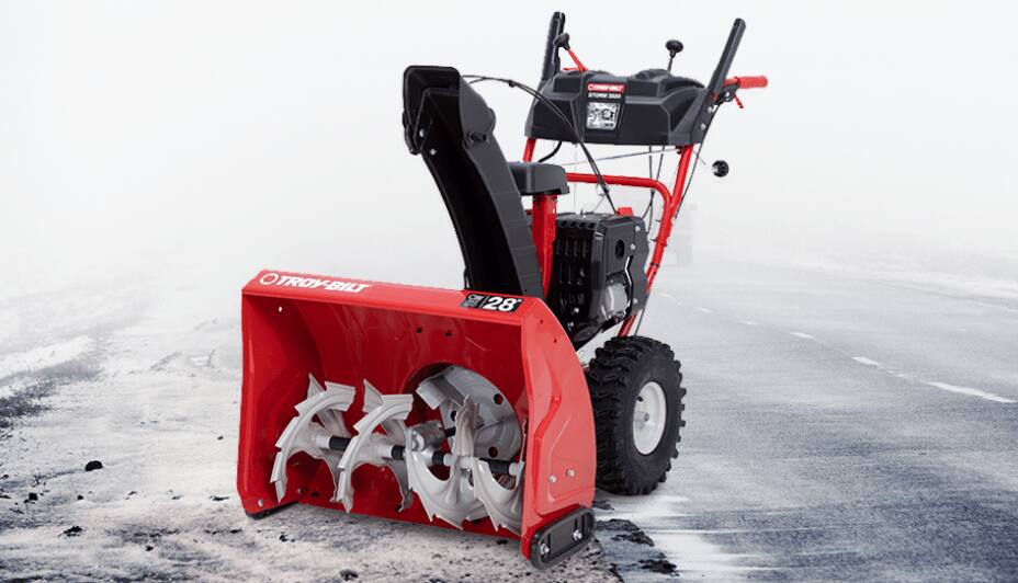 Product shot of Troy-Bilt Gas Snowblower on an icy road.