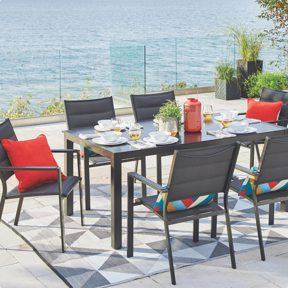 CANVAS Mercier Dining Table set up on lakeside patio balcony with 6 chairs and glass top dining table.  