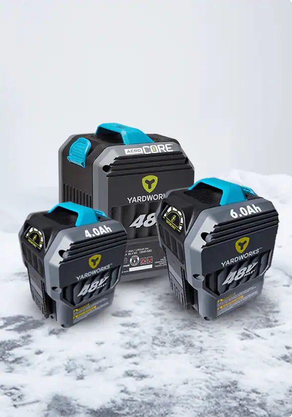 Product shot of three Yardworks 48V battery platforms in snowy background.