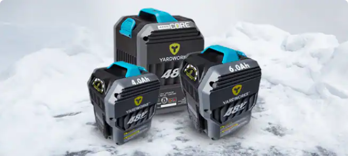 Product shot of three Yardworks 48V battery platforms in snowy background.