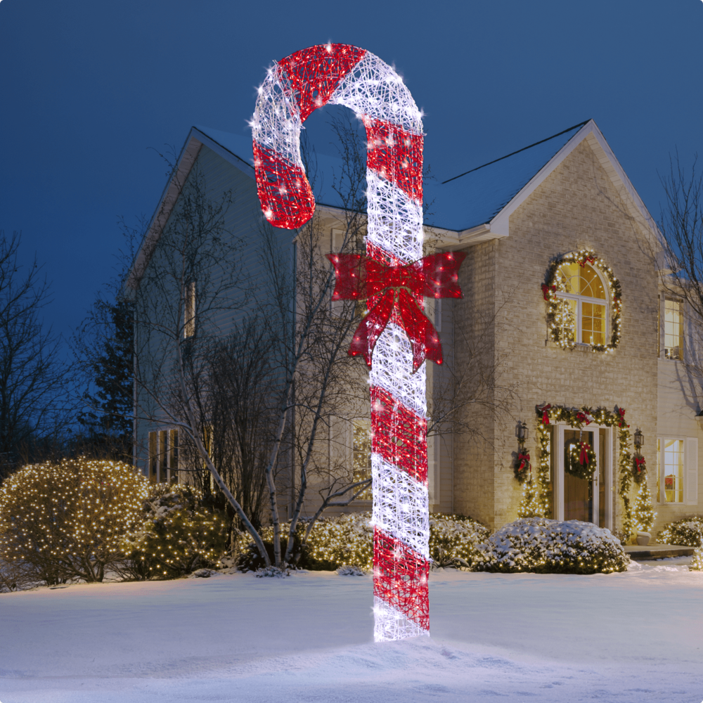 CANVAS 8-ft LED Candy Cane in front of a home.