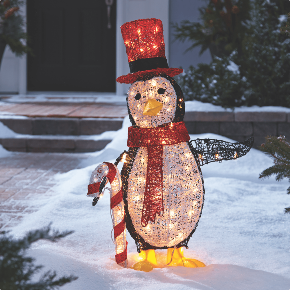 CANVAS 3-ft Whimsical LED penguin on a snowy front lawn.