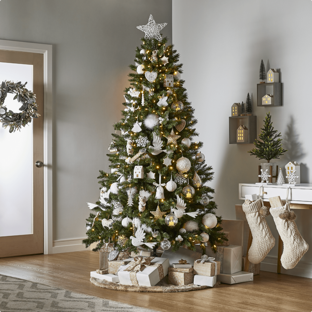 NOMA Pre-Lit LED 7-ft Henry Fir Christmas tree in a modern home. 