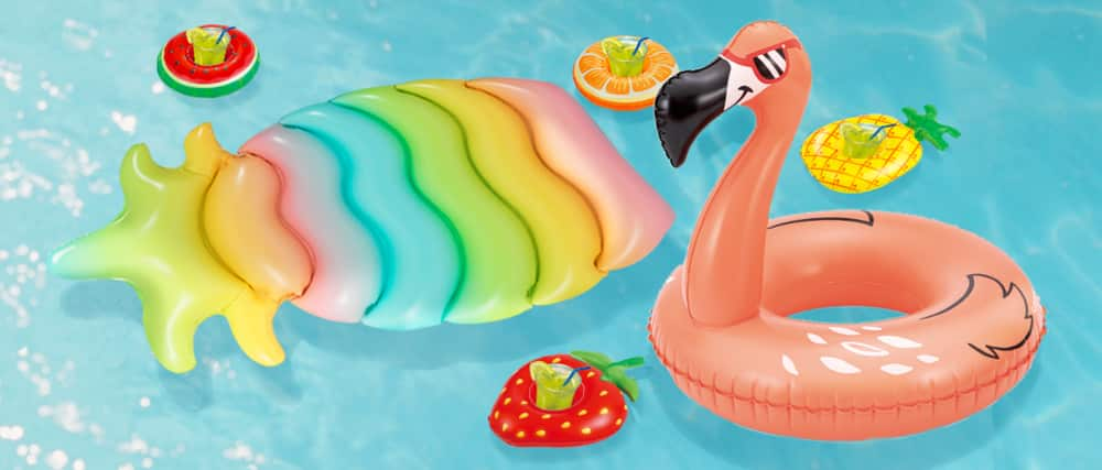 Bouée flamant rose et chaise longue ananas dans une piscine