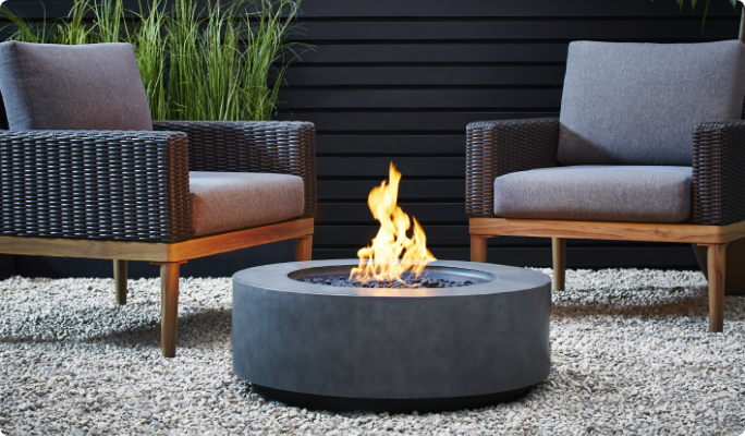 Outdoor fire pit with patio chairs.