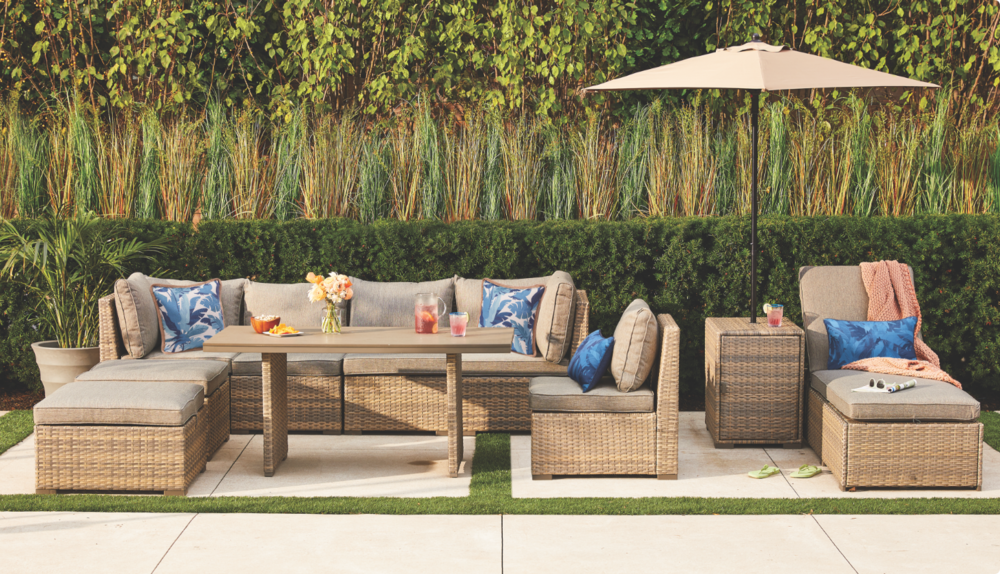 Patio conversation set and outdoor umbrella in backyard.