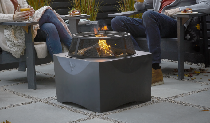 Couple lounging by outdoor firepit