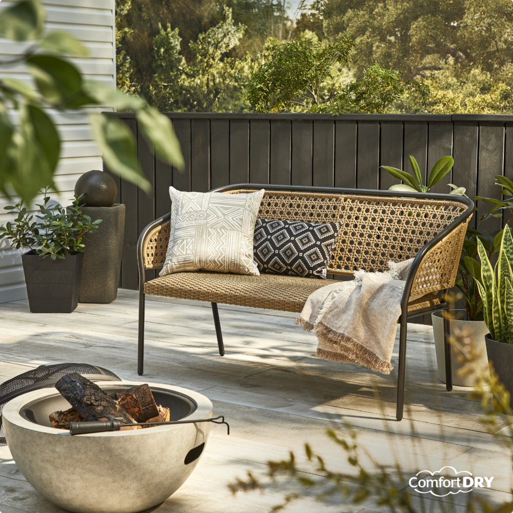 CANVAS Chambly Bench on backyard patio with decorative pillows and blanket.