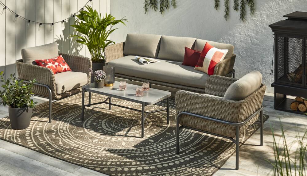 CANVAS Gates Conversation Set on backyard patio with coffee table, loveseat and two club chairs. 
