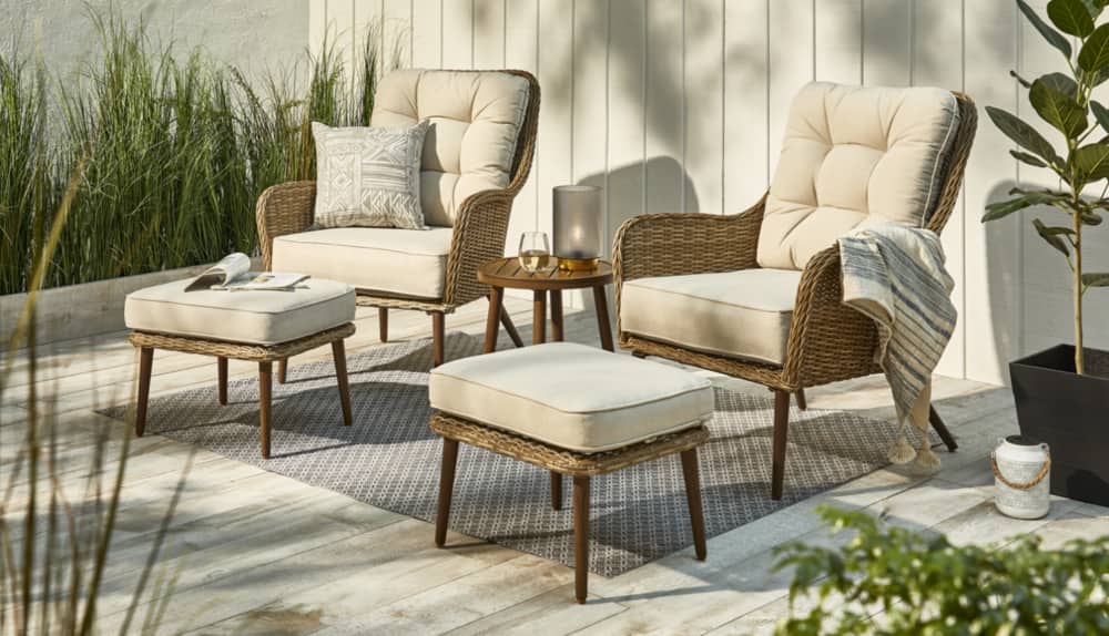 CANVAS Pelly Chat Set on backyard patio with seats, ottomans and side table. 