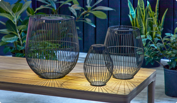 CANVAS Shore Nesting Lanterns on wooden table in backyard.  