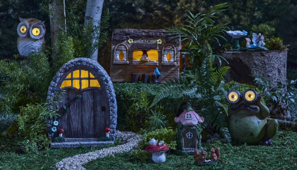 For Living Stone Door Decor and Cafe Fairy House in greenery during nighttime.