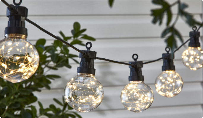 CANVAS Enchant Garden String Lights hung in backyard patio.  