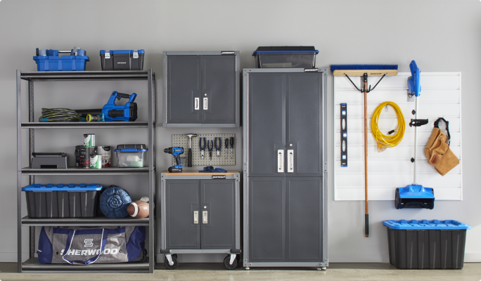 Mastercraft shelving, racks, tool cabinets and tools along a garage wall.