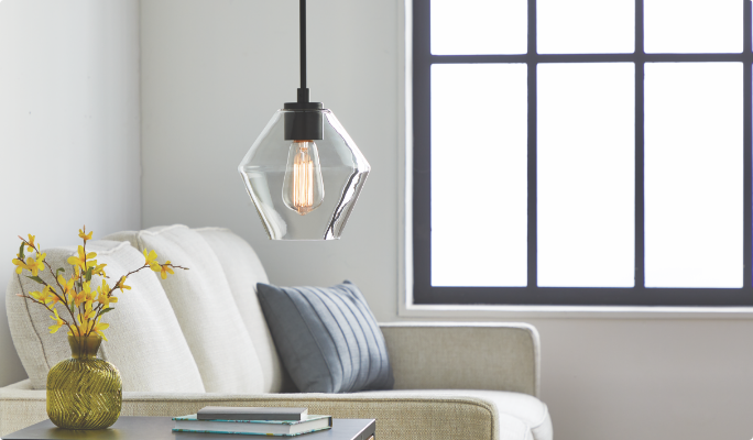 A pendant light with an Edison bulb in a living room.