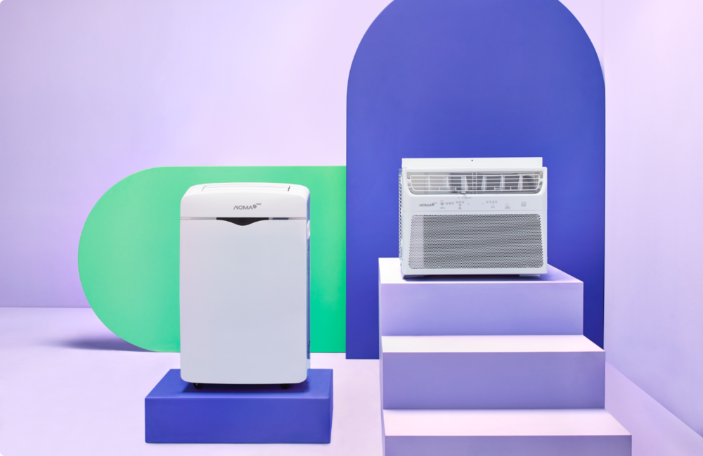 Two NOMA iQ air purifiers set on a living room floor