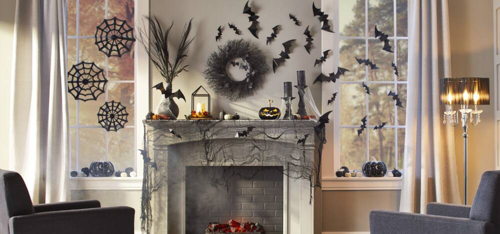 A home's fireplace area accessorized with Halloween decorations.