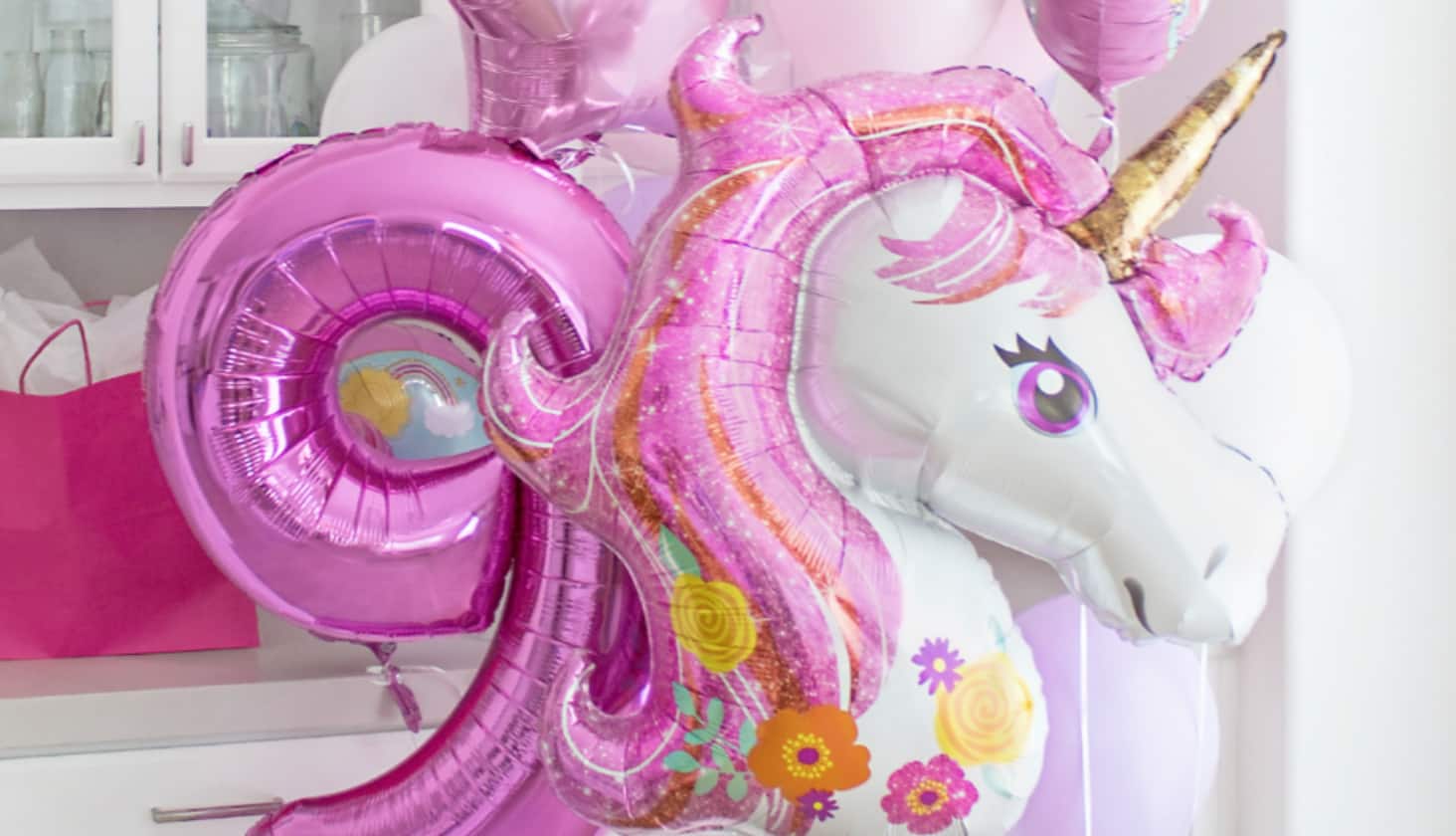 Large Unicorn mylar balloon, with pink metallic number balloons.