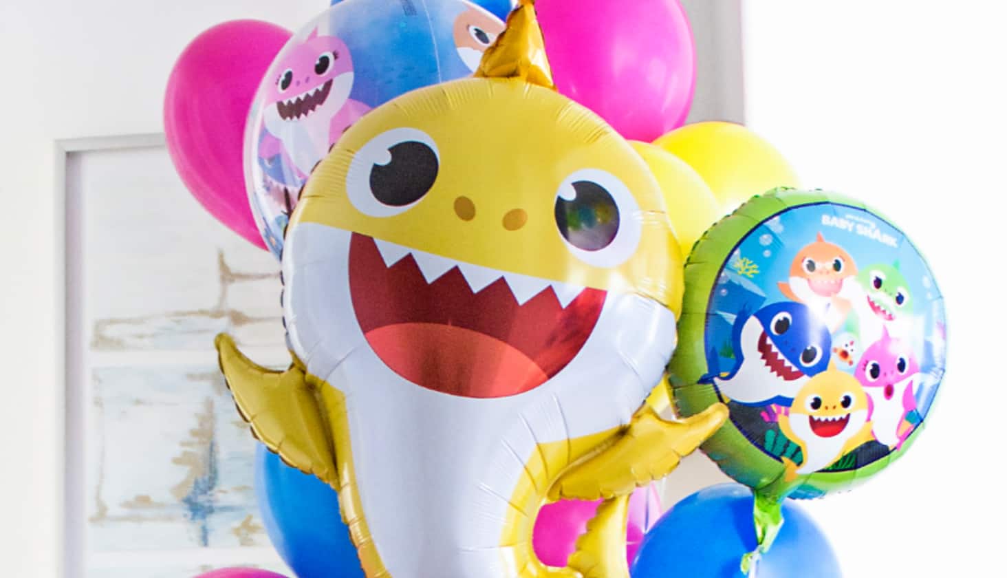 Colourful Baby Shark characterthemed bouquet with a jumbo yellow shark-shaped mylar in the centre. 