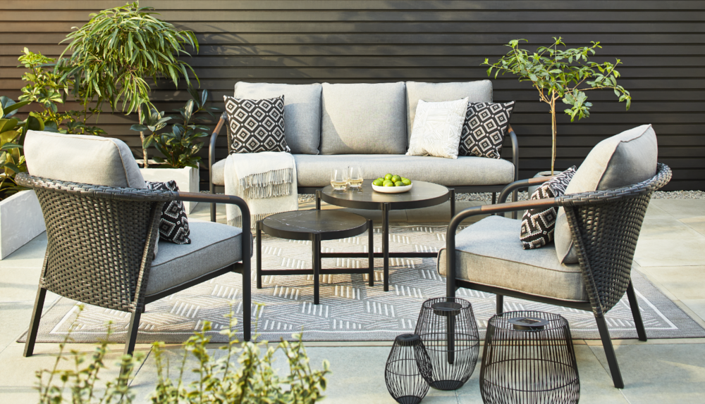 A CANVAS Jasper Outdoor Couch, nesting tables and armchairs on a patio