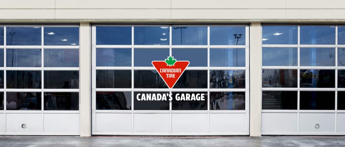 A set of rolling steel garage doors bearing the Canadian Tire logo and the words "Canada's Garage."
