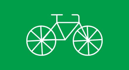 Line drawing of a bicycle on a green background.