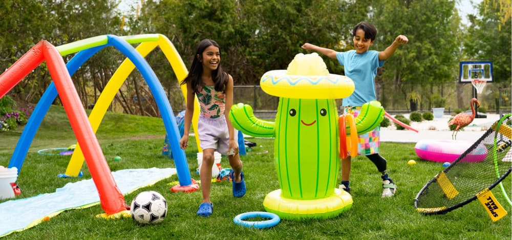 Two kids playing with backyard games and toys