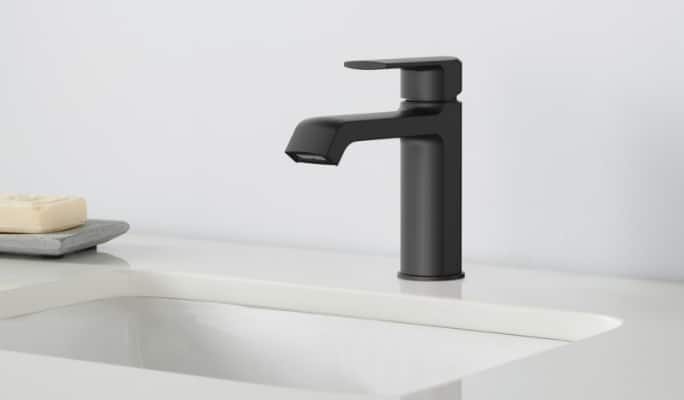 A Danze Karter 1-Handle Lavatory Faucet, black finish, by a white ceramic bathroom sink.