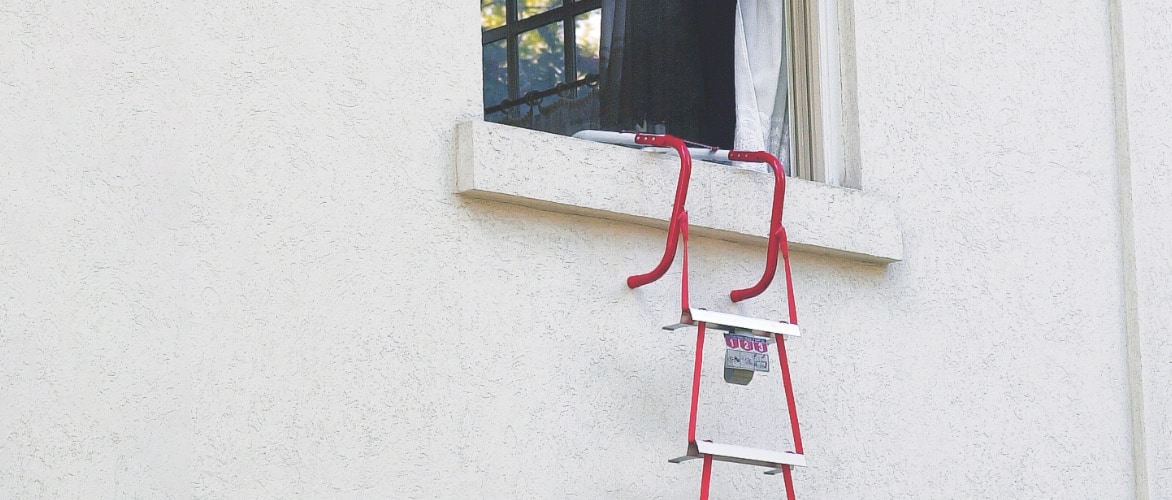Emergency fire escape ladder hanging out of window