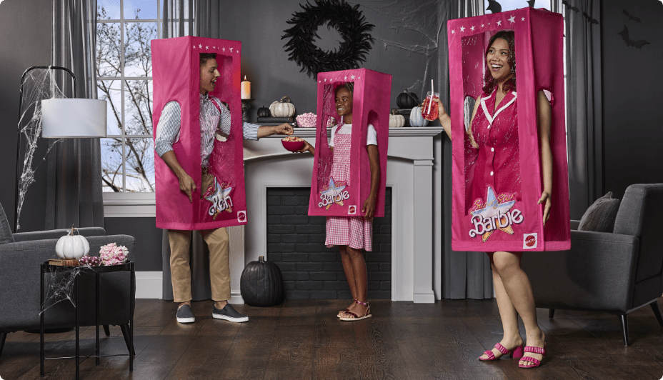 Kids wearing Barbie and Ken costume boxes.