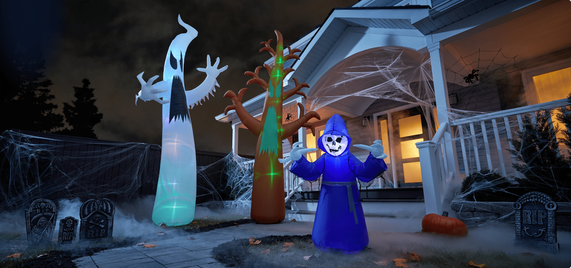 Spooky Halloween inflatables on lawn.