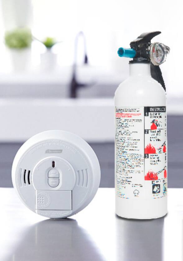 Smoke alarm and fire extinguisher on kitchen counter