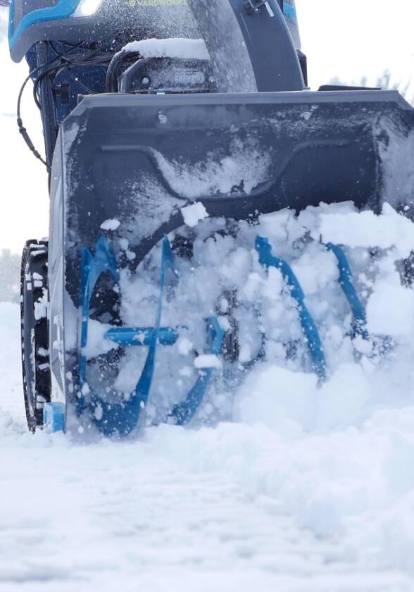 Snow blower picking up snow.