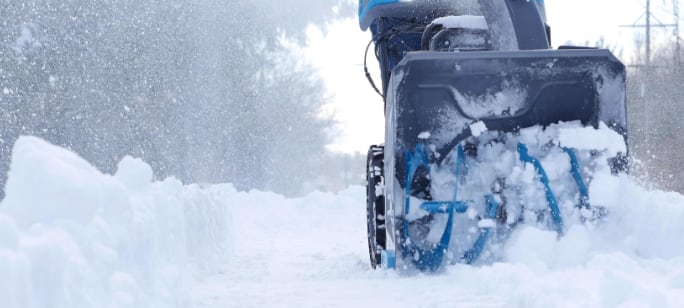 Snow blower picking up snow.