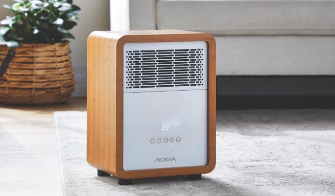 NOMA space heater with wood grain finish and a white faceplate.