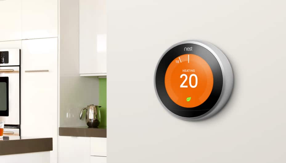 Google Nest smart thermostat mounted on a wall