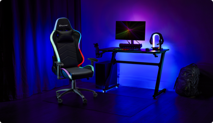 An X Rocker Strike RGB Ergonomic Adjustable Swivel PC Gaming/Office Chair in front of a minimalist gaming setup.