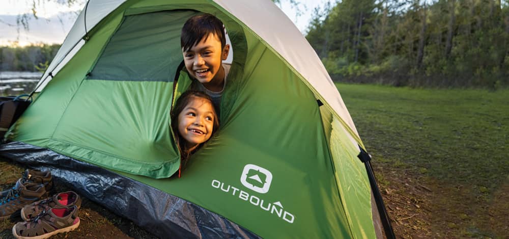 Two kids in an Outbound tent
