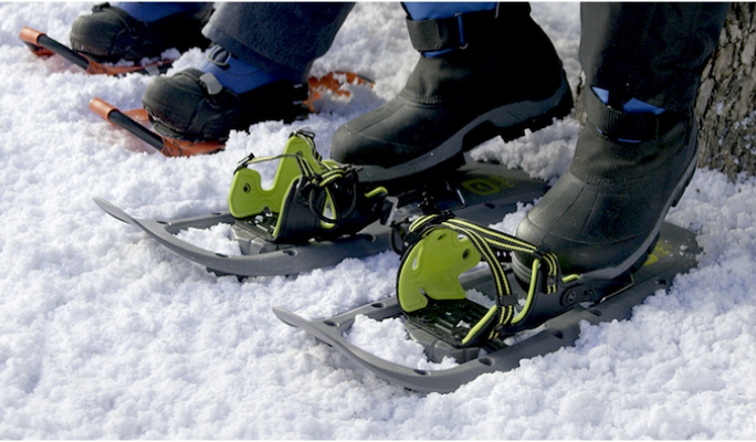 People strapping on snowshoes  