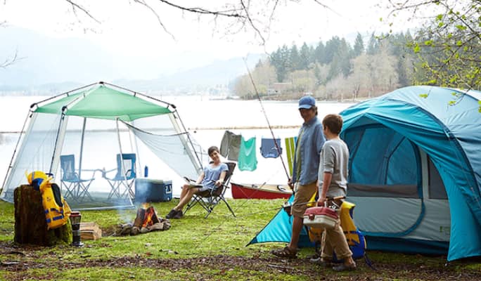People at a campsite with tents   