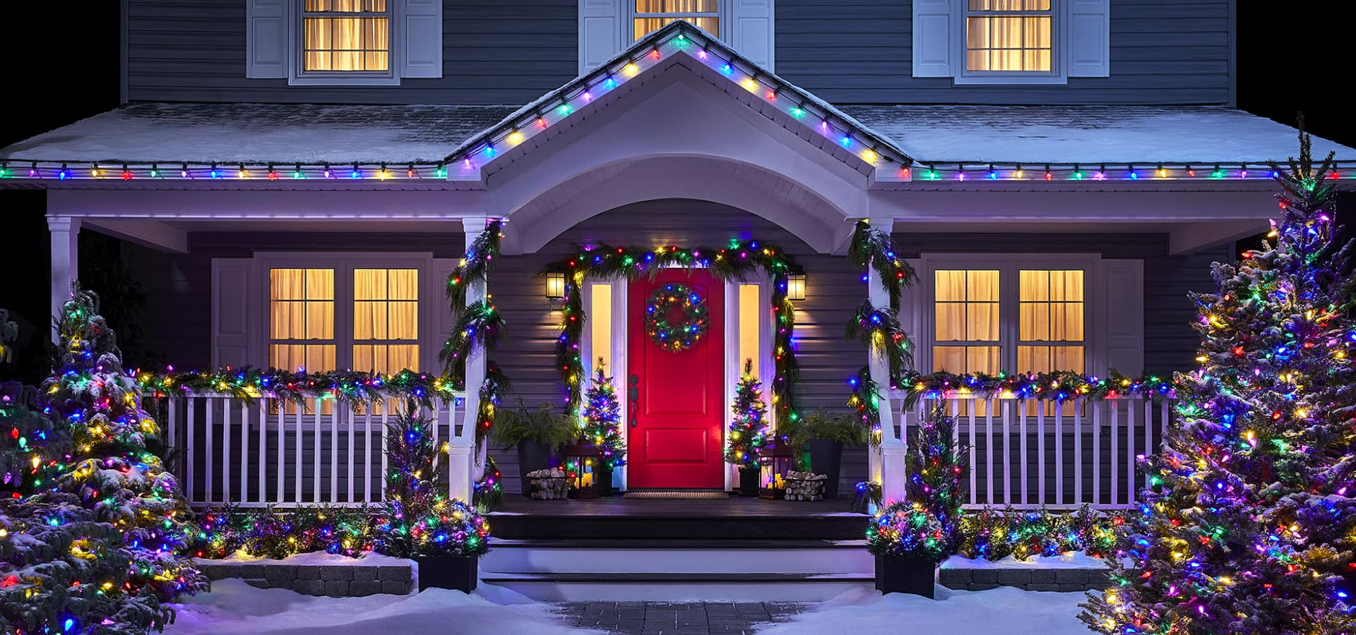 Exterior of a home decorated with Christmas decorations and colourful lights