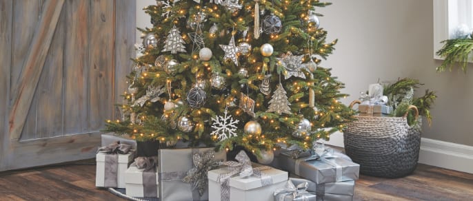 Christmas tree with presents underneath in a living room
