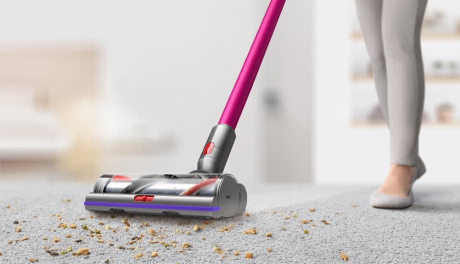Woman using a Bissel carpet cleaner on the floor