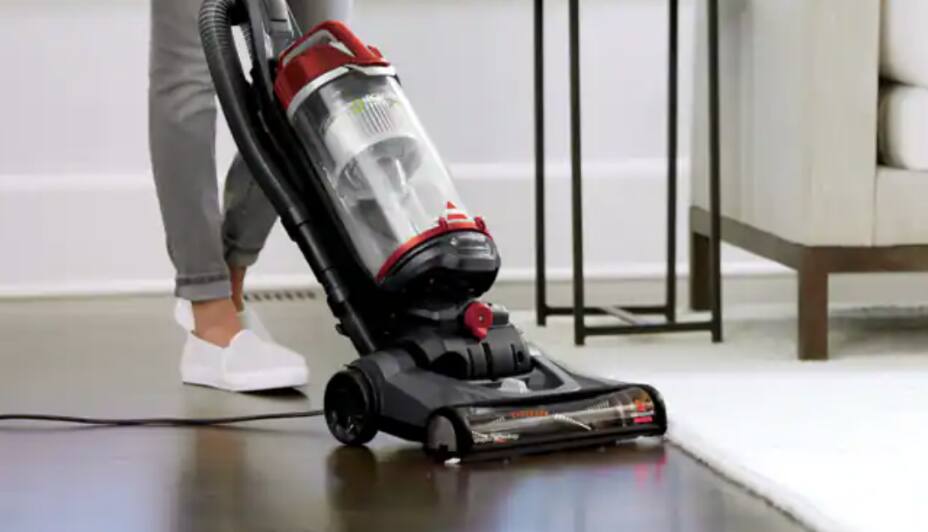Person pushing vacuum over wood floors