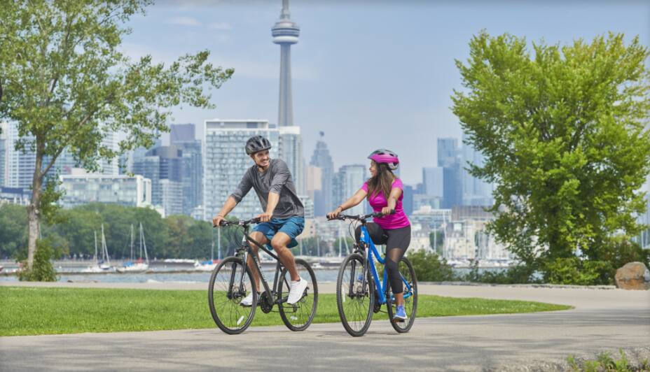 People riding bikes with CN tower in the background