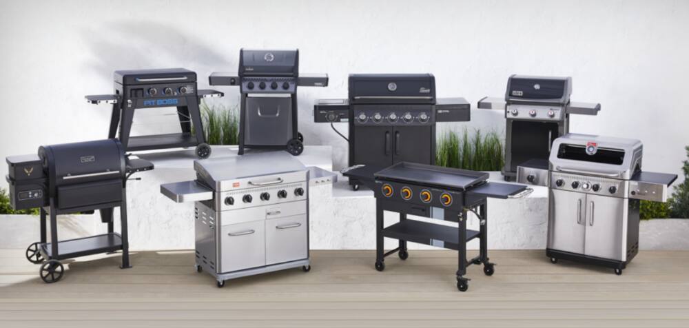8 different types of BBQs on display outdoors. 