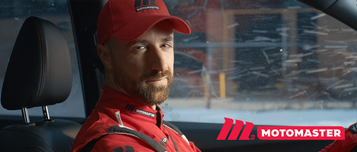 Auto racer James Hinchcliffe in the driver’s seat of a car.